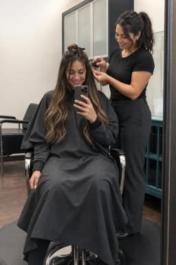 Client and beauty professional together during an extension appointment